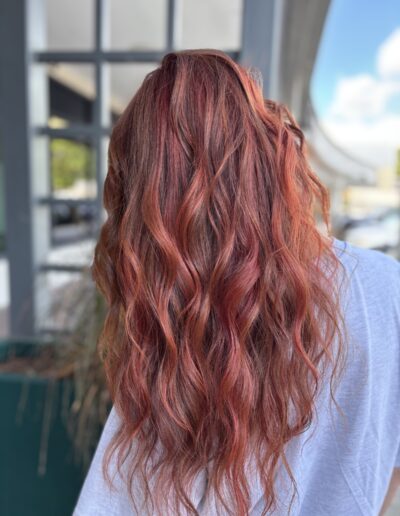 Copper red balayage on long wavy hair, back view, by Milk + Honey in Cary, NC