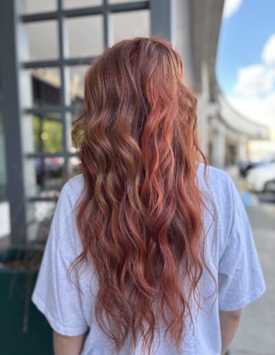 Hand-painted copper balayage with soft beach waves at Milk + Honey Cary salon